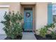 Inviting home exterior with teal front door, landscaping, and walkway at 2128 Silver Brook Way, Davenport, FL 33837