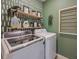 Laundry room with washer, dryer, and stylish shelving at 2128 Silver Brook Way, Davenport, FL 33837