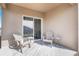 Relaxing patio with two chairs and small side table at 2128 Silver Brook Way, Davenport, FL 33837