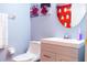 Clean bathroom with white vanity and Mickey Mouse shower curtain at 227 Verona Ave, Davenport, FL 33897