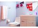 Clean bathroom with white vanity and Mickey Mouse shower curtain at 227 Verona Ave, Davenport, FL 33897