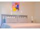 King size bed with light gray bedding and artwork above at 227 Verona Ave, Davenport, FL 33897