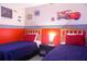 Twin bedroom with Cars theme, featuring two beds and nightstands at 227 Verona Ave, Davenport, FL 33897