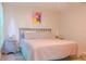 King size bed with light gray bedding and artwork above at 227 Verona Ave, Davenport, FL 33897