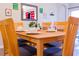 Bright dining area with wood table and chairs, view of kitchen at 227 Verona Ave, Davenport, FL 33897