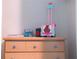 Wooden dresser with multiple drawers and various items on top at 227 Verona Ave, Davenport, FL 33897