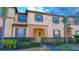 Two-story townhome with landscaping and brick walkway at 227 Verona Ave, Davenport, FL 33897