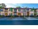 Townhome community with palm trees and paved road at 227 Verona Ave, Davenport, FL 33897