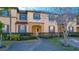Two-story townhome with landscaping and brick driveway at 227 Verona Ave, Davenport, FL 33897