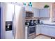 Modern kitchen with stainless steel appliances and granite counters at 227 Verona Ave, Davenport, FL 33897