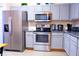 Modern kitchen with stainless steel appliances and granite counters at 227 Verona Ave, Davenport, FL 33897