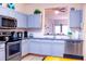 Modern kitchen with stainless steel appliances and breakfast bar at 227 Verona Ave, Davenport, FL 33897