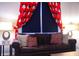 Living room with Mickey Mouse curtains and a brown couch at 227 Verona Ave, Davenport, FL 33897
