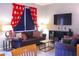 Living room with Mickey Mouse curtains, comfy sofas, and a large TV at 227 Verona Ave, Davenport, FL 33897