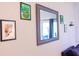 Wall with framed art and a large mirror reflecting light at 227 Verona Ave, Davenport, FL 33897