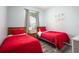 Twin bedroom with red bedding and playful wall art at 2300 Butterfly Palm Way # 205, Kissimmee, FL 34747