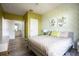Guest bedroom with a light beige bedspread and green geometric wallpaper at 2300 Butterfly Palm Way # 205, Kissimmee, FL 34747