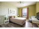 Bedroom with a queen bed, geometric wallpaper and a teal chair at 2300 Butterfly Palm Way # 205, Kissimmee, FL 34747