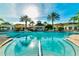 Large community pool with lounge chairs and palm trees at 2300 Butterfly Palm Way # 205, Kissimmee, FL 34747