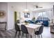 Bright dining area with table, chairs, and living room view at 2300 Butterfly Palm Way # 205, Kissimmee, FL 34747