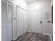 Bright entryway with wood-look floors, double closets, and white doors at 2300 Butterfly Palm Way # 205, Kissimmee, FL 34747
