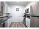 Modern kitchen with stainless steel appliances and white cabinets at 2300 Butterfly Palm Way # 205, Kissimmee, FL 34747