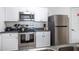 Stainless steel appliances and white cabinets in kitchen at 2300 Butterfly Palm Way # 205, Kissimmee, FL 34747