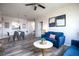 Bright living room with dining area, hardwood floors, and comfy blue sofa at 2300 Butterfly Palm Way # 205, Kissimmee, FL 34747