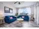 Living room with blue sofas, coffee table, and wood floors at 2300 Butterfly Palm Way # 205, Kissimmee, FL 34747
