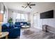 Living room with blue sectional sofa and large TV at 2300 Butterfly Palm Way # 205, Kissimmee, FL 34747