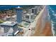 Stunning aerial view of the property with beach access, nearby hotels and beautiful coastline at 2626 S Atlantic Ave # 102, Daytona Beach Shores, FL 32118