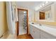 Bright bathroom featuring a vanity, mirror, and shower with black and white curtain at 2626 S Atlantic Ave # 102, Daytona Beach Shores, FL 32118