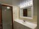 Bathroom with vanity, large mirror, and access to shower at 2626 S Atlantic Ave # 102, Daytona Beach Shores, FL 32118