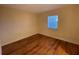 Simple bedroom with wood-look floors and window with blinds at 2626 S Atlantic Ave # 102, Daytona Beach Shores, FL 32118