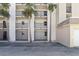 Apartment exterior featuring balconies, parking, and palm trees at 2626 S Atlantic Ave # 102, Daytona Beach Shores, FL 32118