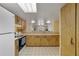 Kitchen with tiled floors, light cabinets, and open view to living area at 2626 S Atlantic Ave # 102, Daytona Beach Shores, FL 32118