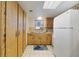 Kitchen with light wood cabinets and white tile flooring and appliances at 2626 S Atlantic Ave # 102, Daytona Beach Shores, FL 32118