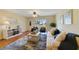 Bright living room with stylish seating, ceiling fan, wood floors, and sliding door to the outside at 2626 S Atlantic Ave # 102, Daytona Beach Shores, FL 32118