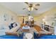 Open living room and dining area with hardwood floors, ceiling fan, and modern decor at 2626 S Atlantic Ave # 102, Daytona Beach Shores, FL 32118