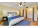 Comfortable bedroom featuring a ceiling fan, wood floors, and access to closet space at 2626 S Atlantic Ave # 102, Daytona Beach Shores, FL 32118