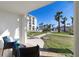 Relaxing patio view with lush greenery, palm trees, and pool area at 2626 S Atlantic Ave # 102, Daytona Beach Shores, FL 32118