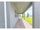 Covered back porch showcasing a brick paver floor, recessed lights and an outdoor space for relaxation at 2678 Great Heron Ave, St Cloud, FL 34773