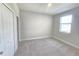 Bright and airy bedroom featuring neutral tones, plush carpet, and a window at 2678 Great Heron Ave, St Cloud, FL 34773