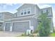 Beautiful exterior view of the two-story home with lush landscaping around the base at 2678 Great Heron Ave, St Cloud, FL 34773