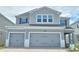Charming two-story home features a two-car garage and a modern gray facade at 2678 Great Heron Ave, St Cloud, FL 34773