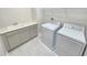 Functional laundry room features ample cabinet space and modern washer and dryer at 2678 Great Heron Ave, St Cloud, FL 34773
