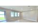 A bright living room features recessed lighting, large windows, and sliding glass doors creating an airy and inviting space at 2678 Great Heron Ave, St Cloud, FL 34773
