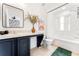 Clean bathroom with tub and dark vanity at 2735 Calabria N Ave, Davenport, FL 33897