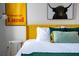 Bedroom with yellow headboard, artwork, and side table at 2735 Calabria N Ave, Davenport, FL 33897