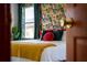 Bedroom with tropical print wallpaper and a comfortable bed at 2735 Calabria N Ave, Davenport, FL 33897